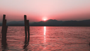 Pink sun setting over ocean