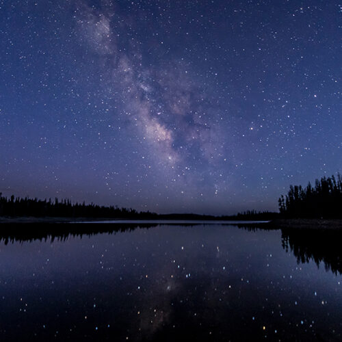 Starry night sky over lake